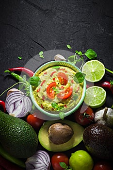 Background bowl guacamole tomato chilli pepper lime onion garlic dill and oregano