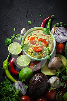 Background bowl guacamole tomato chilli pepper lime onion garlic dill and oregano