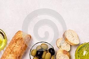 Background with Bowls with Green and Black Olive Olive Oil Artisan Bread Mediterranean Food Light Gray Background Copy Space