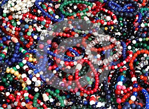 background of bracelets and necklaces made of colorful beads and