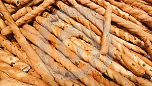 Background of breadsticks or grissini with seeds