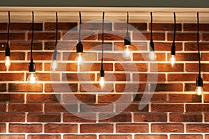 Background of brick wall and decorative incandescent lamps