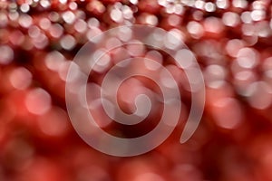 Background with bright red and white circles of different sizes, with dark blotches. From blur bokeh to sharpness photo