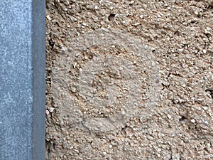 Background with brown color cement wall post and broken small pebbles