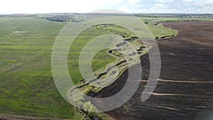 Background of brown earth at high altitude aerial view. Aerial drone view of freshly plowed field ready for seeding and planting