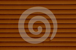 Background of the brown plastic siding. Plastic siding surface in brown tone. Abstract background and texture.