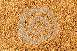 Background of brown raw sugar demerara, top view