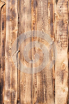 Background, burnt pine boards with a pronounced wood texture