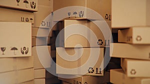 Background of cardboard boxes inside warehouse, logistic center. Warehouse filled with cardboard boxes. Mess in the