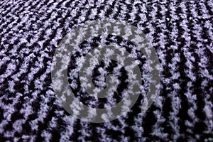 The background of the carpet made of wool with a small pile of white and black colors