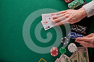 Background for a casino, poker table the player holds a pair of aces. With space