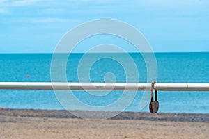 Background chain metal blurred sea old love rusty selective padlock, concept lock iron from railing from lover dating