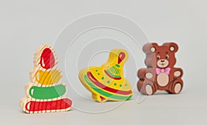 Background of children`s colorful wooden toy figures for children on a light background. vertical view close-up