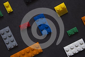 Background for children`s site, for the menu. Children`s constructors on black. Multi-colored cubes. Games for motor developing