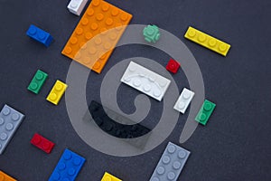 Background for children`s site, for the menu. Children`s constructors on black. Multi-colored cubes. Games for motor developing