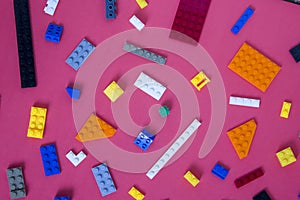 Background for children`s site, for the menu. Children`s constructors on pink. Multi-colored cubes. Games for motor developing mem