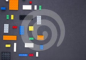 Background for children`s site, for the menu. Children`s constructors on black. Multi-colored cubes. Games for motor developing