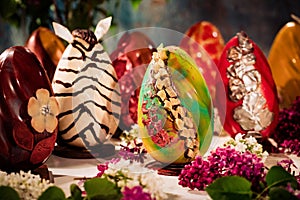 Background with chocolate eggs. Easter eggs with chocolate theme. Unique chocolate designs.