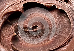 Background of chocolate ice cream - close-up, summer dessert, sweets. Scooped chocolate ice cream or chocolate ice cream from top