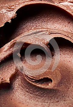 Background of chocolate ice cream - close-up, summer dessert, sweets. Scooped chocolate ice cream or chocolate ice cream from top