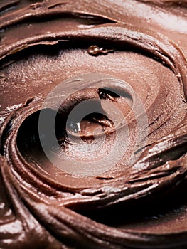 Background of chocolate ice cream - close-up, summer dessert, sweets. Scooped chocolate ice cream or chocolate ice cream from top