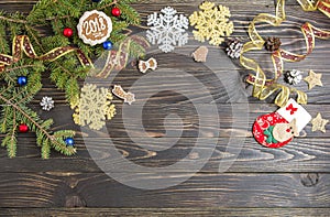 Background for Christmas menu. Cookie, fir and decoration on the old wooden table.