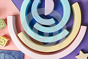 background with circles. Wooden kids toys on colourful paper. Educational toys blocks. Toys for kindergarten, preschool or daycare