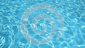 Background of clean water in a blue swimming pool