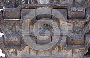 Background Close-up on a rusty old caterpillar tank worn on wheels standing on the road. Tracks armored vehicles