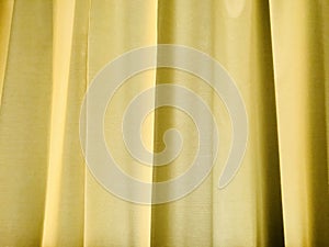 Yellow curtain as background. Backlight.