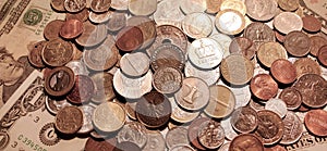 Background of coins lying on paper banknotes of United States.