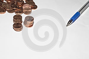 Background with coins and pen on top of a sheet of paper