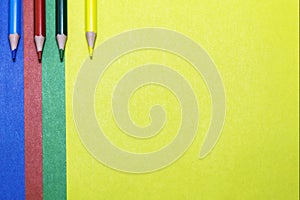 Background of colored paper and colored pencils