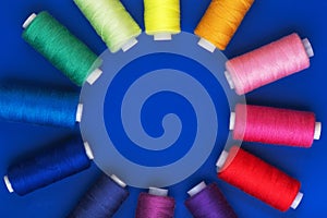 Background with colored sewing thread red blue