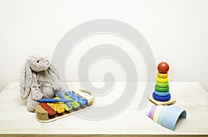 Background of Colorful Children`s toys against the wall Toys on Wood Table with Copy Space for Text