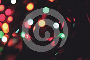 Background colorful Christmas lights on a dark background, blurred abstract Christmas garland