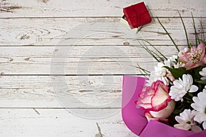 Background with colorful flowers on an old white wooden board