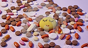 Background of colorful multi-vitamin pills, tablets and capsules . With a sad emoji