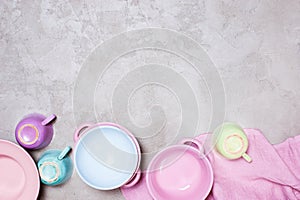 Background with colorful pastel crockery on the light grey table