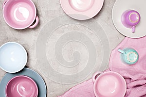 Background with colorful pastel crockery on the light grey table