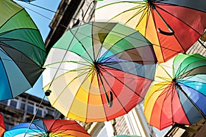 Background colorful rainbow different color umbrellas. unban tourist street decoration