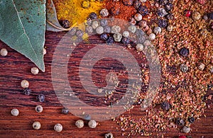 Background with colorful spices on dark brown wood