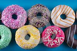 A background of colorful tasty donuts. Close up.