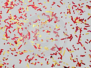 Background confetti red, yellow. Spangles sparkle on pastel gray trendy background. Festive background for your projects