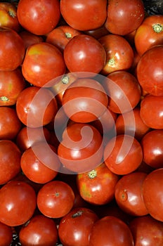 Background consists of ripe juicy red tomatoes.