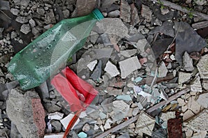 A background of constraction debris and a plastic bottle