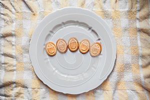 Background with cookies in the shape of Easter eggs with cookies on a gray plate