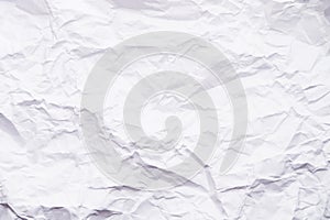 Background of crumpled paper. Close-up of a sheet of white, crumpled, uneven paper. Abstract texture background, copy space