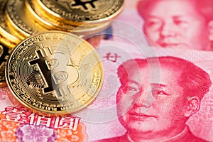 Background with crypto bitcoin and China yuan. Bitcoin with Chinese banknotes.