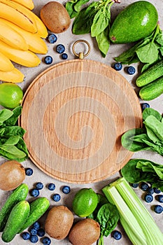 Background with cutting board, fresh healthy vegetables and fruits